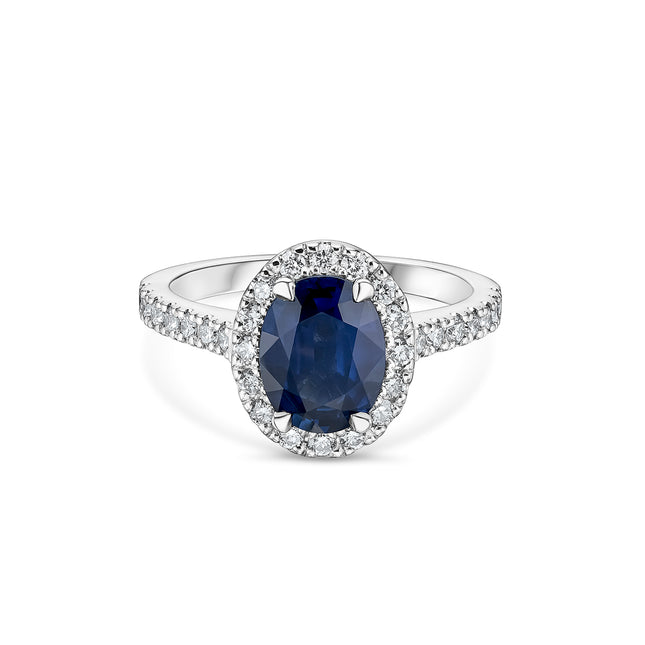 Oval Cut Sapphire and Diamond Halo Ring with Side Stones in Platinum