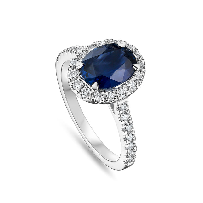 Oval Cut Sapphire and Diamond Halo Ring with Side Stones in Platinum